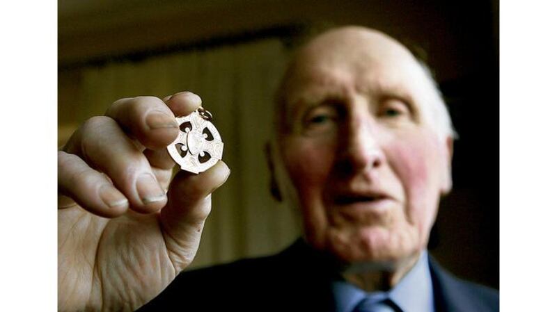 In a picture taken last year, Mick Higgins shows the All-Ireland medal he won with Cavan in the famous 1947 final against Kerry in New York's Polo Grounds. Mick Higgins (Cavan), John Wilson (Cavan), Teddy Sullivan (Kerry), Mick Finnucane (Kerry), Simon Duignan (Cavan), Tony Tighe (Cavan) and Gus Cremin (Kerry) at a lunch in 2005 to celebrate the famous All-Ireland final in New York.