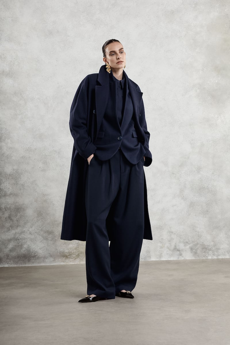 Iona: Rich navy blue herringbone coat worn over matching navy blazer, €1090 and €720