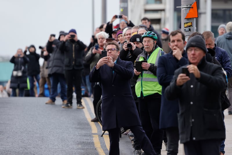 People line the streets as the funeral procession passed down Pearse Street on its way through Dublin.  Photograph: Alan Betson

