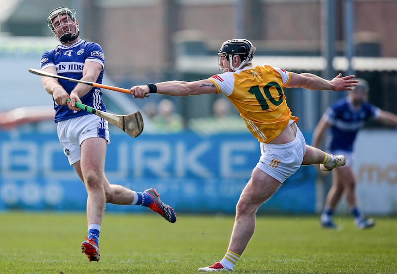 Antrim’s Ryan McCambridge blocks a shot from Laois's Paddy Purcell. Photograph: Leah Scholes/Inpho