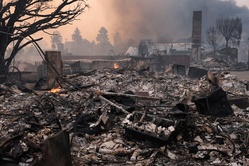 A neighbourhood in the Palisades ravaged by fire stoked by high winds. Photograph: Damian Dovarganes/AP