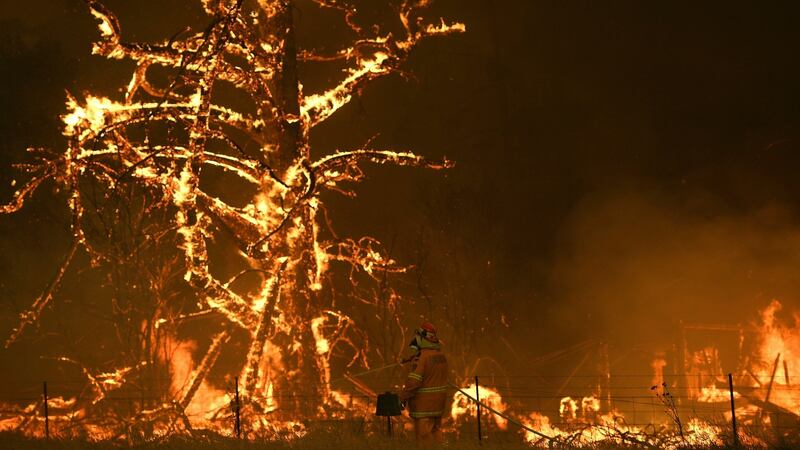 A firew service crew fights the  Gospers Mountain blaze at a property at Bilpin, New South Wales state. Photograph: APP