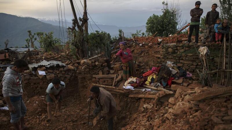 Local villagers search the debris of their house at Paslang village in Gorkha, Nepal. The Department of Foreign Affairs has said that it has yet to make contact with 10 Irish citizens following the disaster. Photograph: Athit Perawongmetha/Reuters