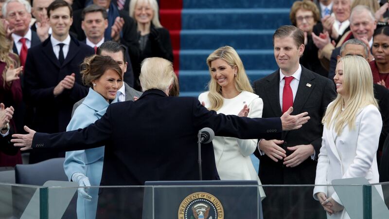 President Donald Trump reaches out to embrace son Barron Trump as First Lady Melania Trump, Ivanka Trump (C), Eric Trump and Tiffany Trump look on after his inauguration on the West Front of the U.S. Capitol in Washington on Friday. Photograph:  Alex Wong/Getty Images