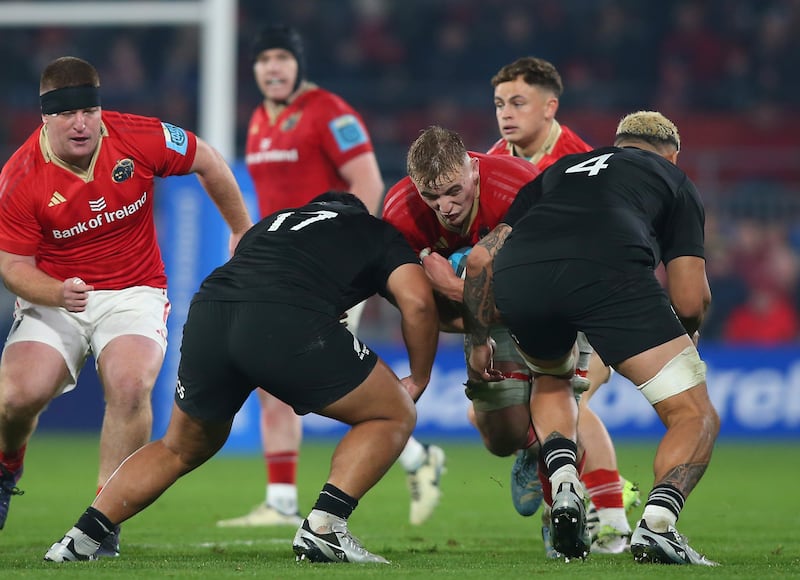 Munster's Gavin Coombes is tackled by All Blacks XV's Xavier Numia and Isaia Walker-Leawere at Thomond Park. Photograph: Ken Sutton/Inpho