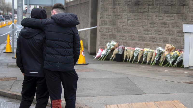 Youths pay their respects and place flowers on Wednesday scene of the death of teenage boy on East Road, Dublin. Photograph: Colin Keegan/ Collins Dublin