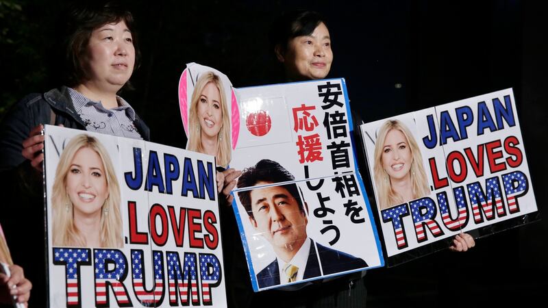 Big in Japan: fans wait for Ivanka Trump outside a restaurant in Tokyo. The Japanese characters in the centre read “Support Prime Minister Abe”. Photograph: Kimimasa Mayama/EPA