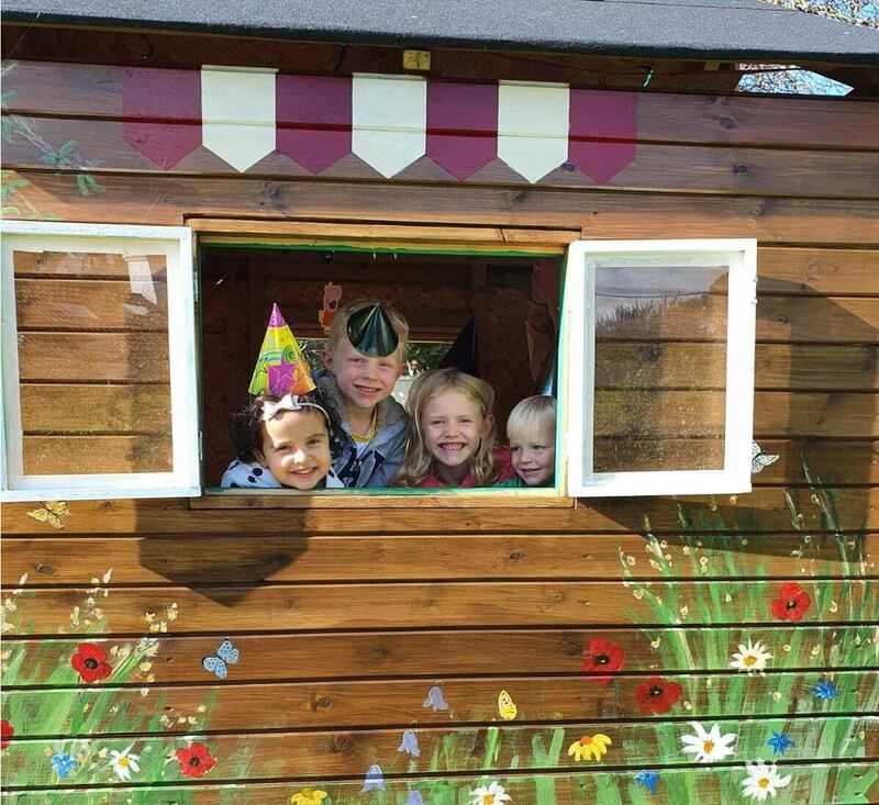 Some of Mary Nohilly's grandchildren enjoying their new play house