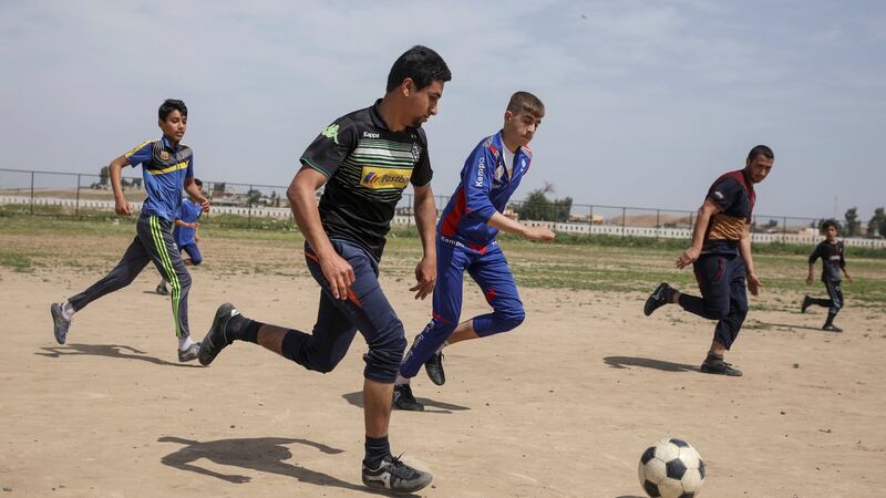 Boys playing soccer in eastern Mosul, an activity that was forbidden under Islamic State. Photograph:  Marko Djurica/Reuters