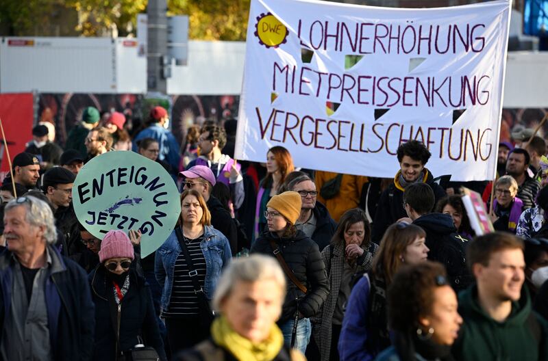 Demonstrators holds up posters and banners reading 'Expropriation now!; and 'Wage increase - Rental price reduction - Socialisation' during a demonstration titled Umverteilen! (Redistribute!) in Berlin in November 2022 to protest against overly expensive rents, rising prices and unaffordable heating costs. Photograph: Tobias Schwarz/AFP via Getty Images