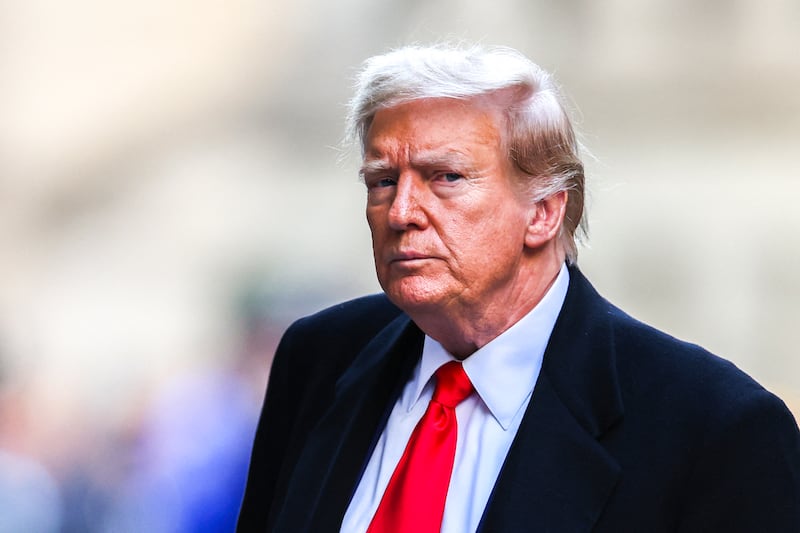 Former US president Donald Trump arrives at Wall Street in New York City after his court hearing to determine the date of his trial for allegedly covering up hush money payments linked to extramarital affairs. Photograph: Charly Triballeau/AFP/Getty 