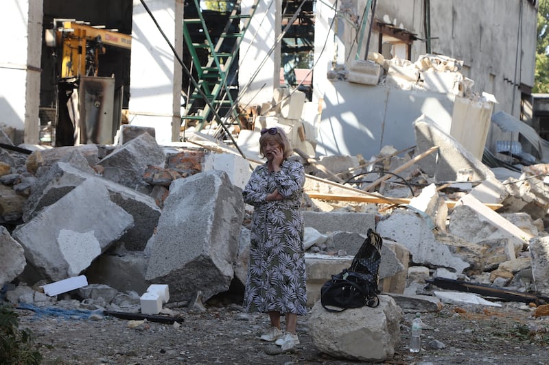 A woman talks on a mobile phone next an industrial building damaged after a Russian attack in Odesa. Photograph: Oleksandr Gimanov/AFP via Getty Images