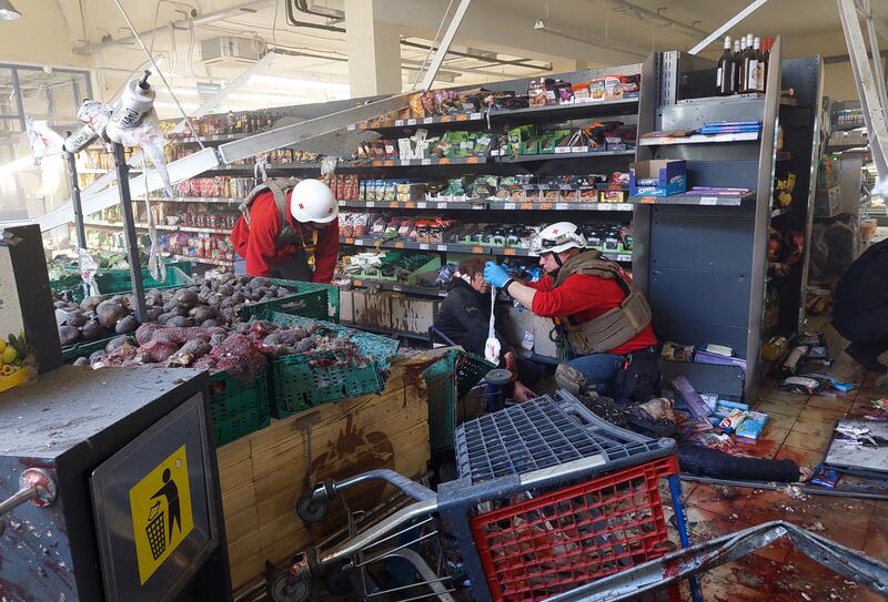 Paramedics help a wounded local resident in a supermarket following Russian strikes in the southern Ukrainian town of Kherson on Wednesday. Photograph: Dina Pletenchuk/AFP