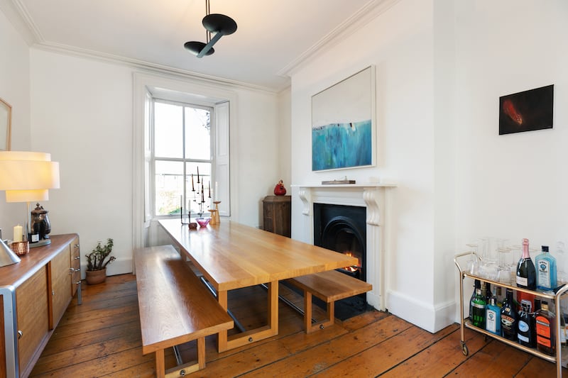 Folding doors lead to a diningroom to the rear, overlooking the west-facing back garden. 