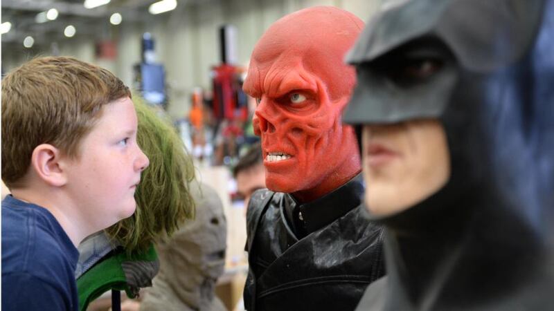 Fionn Fenlon (9), from Swords, Co Dublin, eyes a model of Red Skull, by Johnny Martin, at the Dublin Comic Con. Photograph: Dara Mac Dónaill. See more portraits from Dublin Comic Con in the online gallery at irishtimes.com