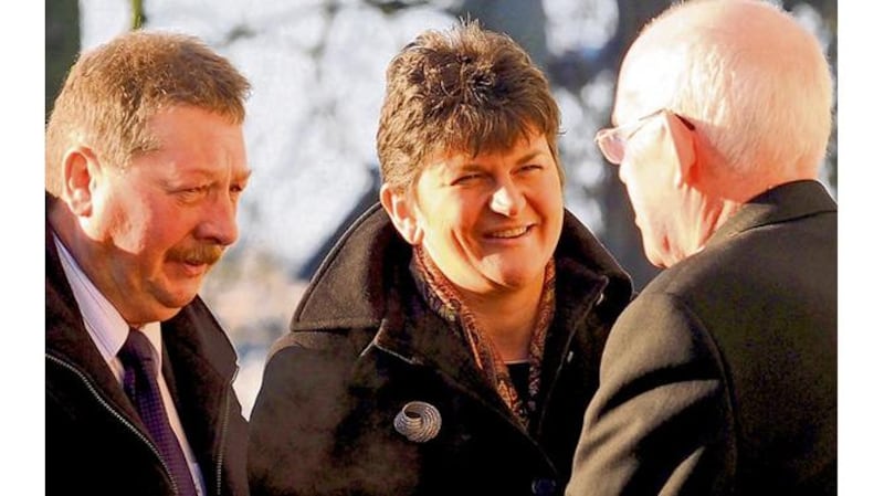 DUP representatives Sammy Wilson and Arlene Foster talk to Cardinal Sean Brady before the funeral.