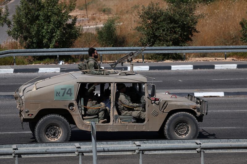 Israeli soldiers aboard a military vehicle at an undisclosed location, near the border with Lebanon in northern Israel. Photograph: Atef Safadi/EPA/EFE