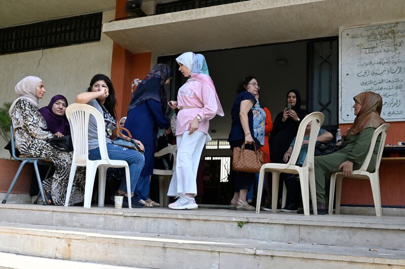 People displaced from south Lebanon sit at the entrance in a local school used as a shelter for the southern port city of Tyre, Lebanon, on October 23rd. Photograph: Wael Hamzeh/Shutterstock