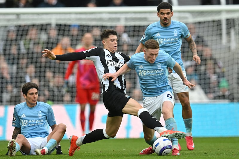 Newcastle United's Lewis Miley tackles Nottingham Forest's Elliot Anderson at St James' Park. Photograph: Andy Buchanan/AFP via Getty Images          
