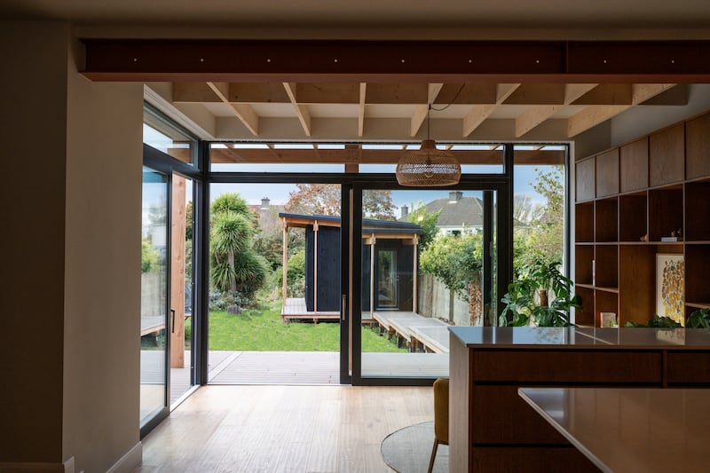 The garden office is linked to the house by a wooden deck