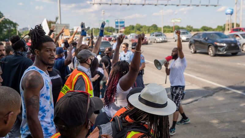 Protesters gather along the Interstate 75-85 Downtown Connector highway near the scene. Photograph: Erik S Lesser/EPA