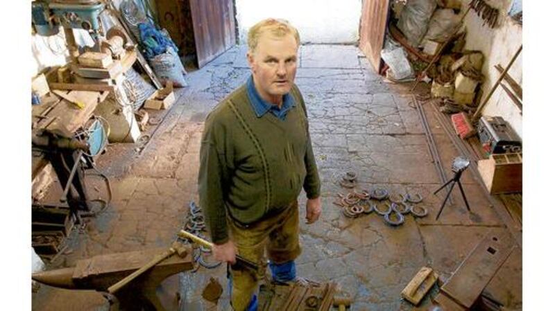 John Brennan, who receives acupuncture to help alleviate back pain, working as a farrier in Croom, Co Limerick