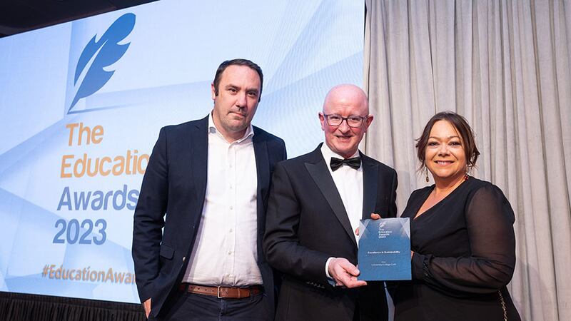 Bertie Kelly, Awards Judge, presents the Excellence in Sustainability award to Niamh McGettrick and Eoin Hahessy, University College Cork.