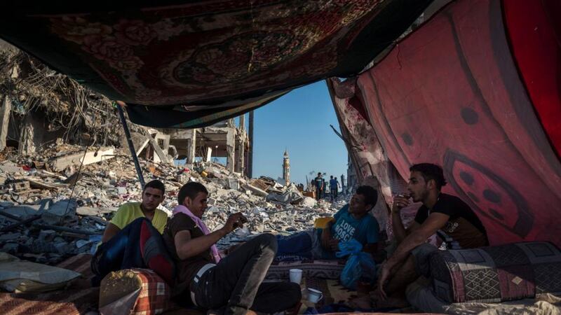 Palestinians rest in a temporary shelter set up outside destroyed homes in Beit Lahiya, in the northern Gaza Strip, yesterday. Phptograph: Sergey Ponomarev/The New York Times