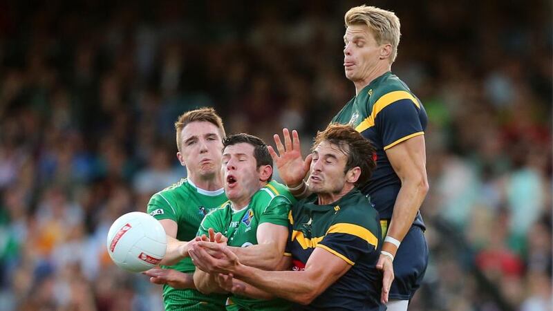 Australia’s Jobe Watson and Nick Riewoldt with Aidan Walsh and Seán Cavanagh of Ireland at Paterson Stadium in Perth. Photograph: Cathal Noonan / Inpho