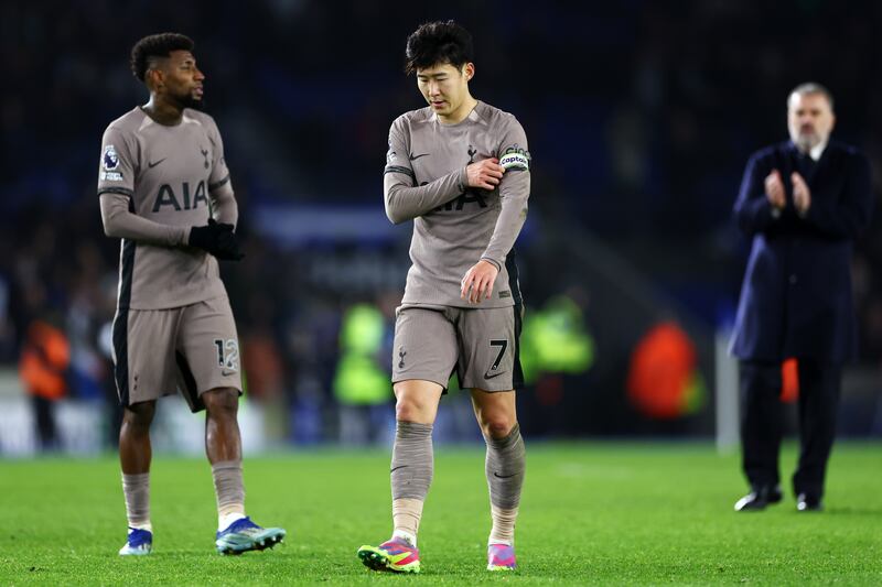 Son Heung-Min of Spurs removing his captain's armband after defeat to Brighton. Photograph: Bryn Lennon/Getty Images