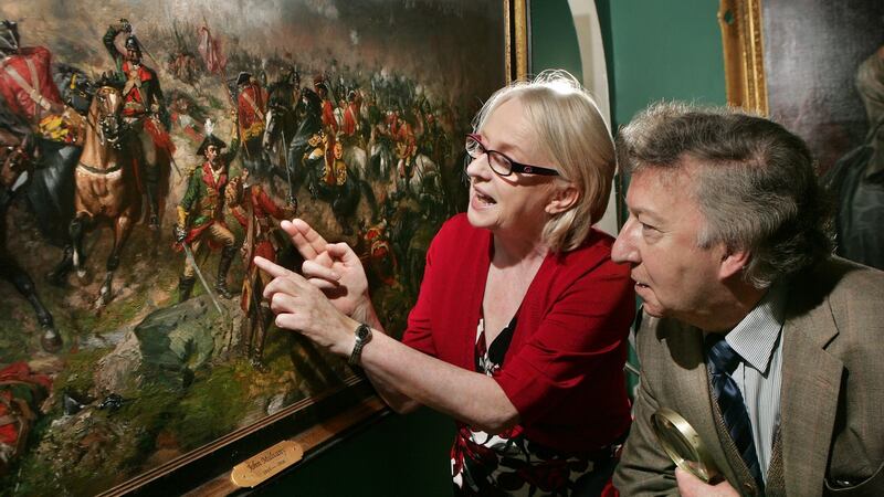 Professor Niamh O’Sullivan and James Gorry, a restoration specialist, discussing a detail in    The Battle of Aughrim by John Mulvany, at the Gorry Gallery in  Dublin. Photograph: Matt Kavanagh