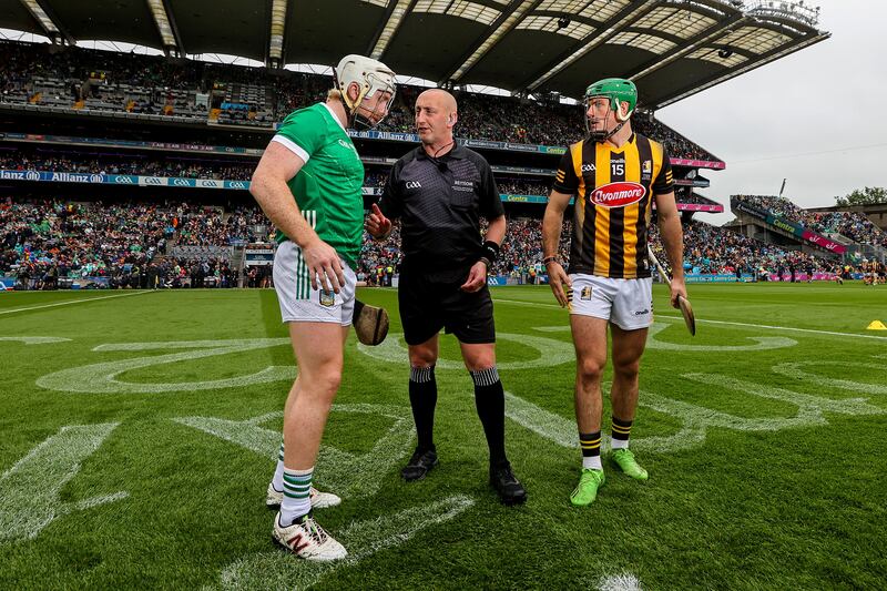 Referee John Keenan with Limerick's Cian Lynch and Eoin Cody of Kilkenny. Photograph: James Crombie/Inpho
