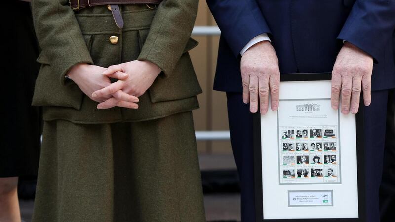 Minister of State for the Diaspora Jimmy Deenihan displays framed An Post commemorative stamps. Photograph: Maxwell Photography