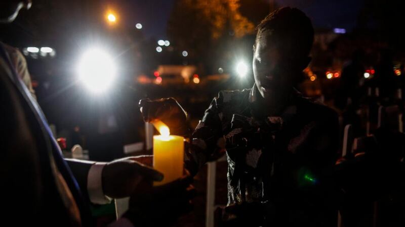 A Kenyan woman lights a candle as she attends a candlelight vigil in downtown Nairobi held for the 148 people killed in an attack on Garissa University College. Photograph: Dai Kurokawa/EPA.