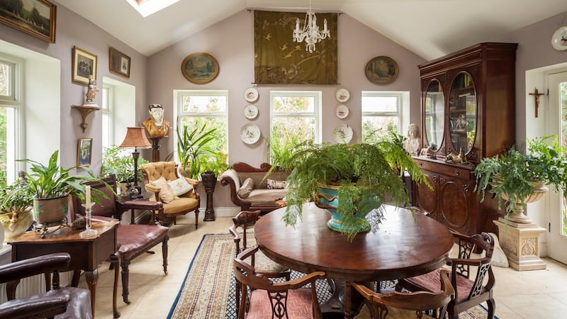 The sun room  is filled with tropical plants