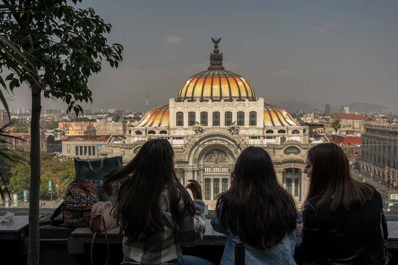 Tourists in front of the Palace of Fine Arts in Mexico City. Photograph: Alejandro Cegarra/New York Times