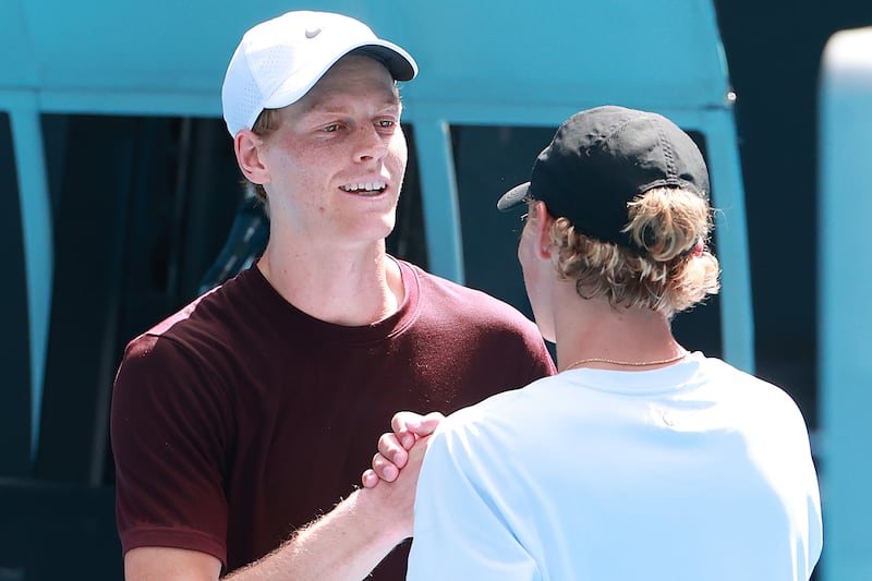 Cruz Hewitt with world No 1 Jannik Sinner (left) following a practice session ahead of the 2025 Australian Open at Melbourne Park. Photograph: Kelly Defina/Getty Images