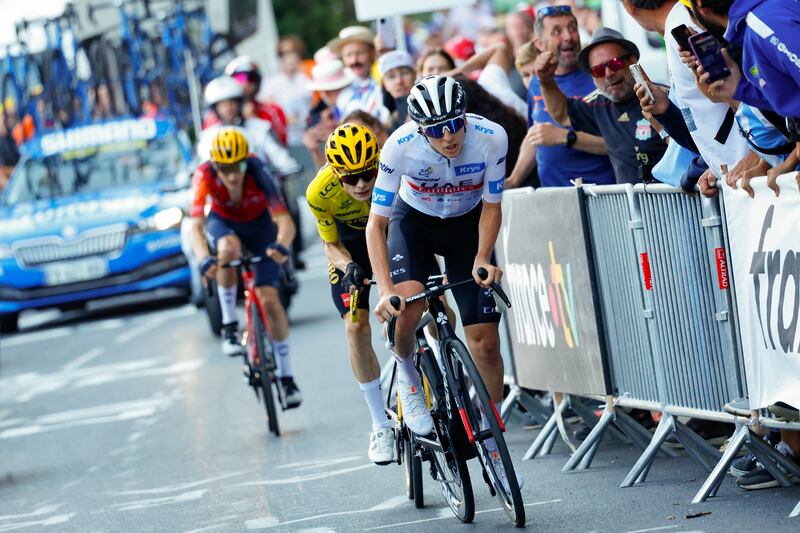 Jonas Vingegaard, wearing the race lleader's yellow jersey, keeps a close  watch on Tadej Pogacar on the final ascent of Saint-Gervais-les-Bains on Sunday. Photograph: Etienne Garnier/AFP via Getty Images