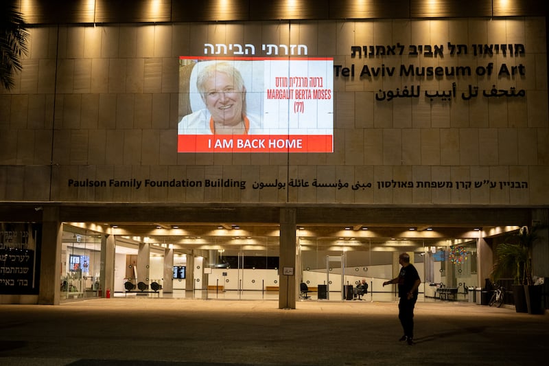 Margalit Moses's face is projected on to a wall outside the Museum of Modern Art in Tel Aviv after her release from Hamas captivity in November 2023. Photograph: Alexi J Rosenfeld/Getty Images