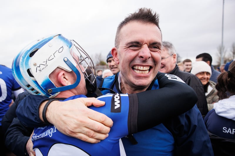 Sarsfields' Liam Healy celebrates with manager Johnny Crowley after reaching the All-Ireland Senior Hurling Club final. Photograph: Ben Brady/Inpho