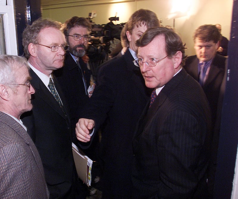 Ulster Unionist Leader David Trimble (right) is ushered past Sinn Féin leader Gerry Adams (third left) and chief negotiator Martin McGuinness  (second left) after peace process talks broke up at Hillsborough Castle in March 2001. Photograph: Paul Faith/PA