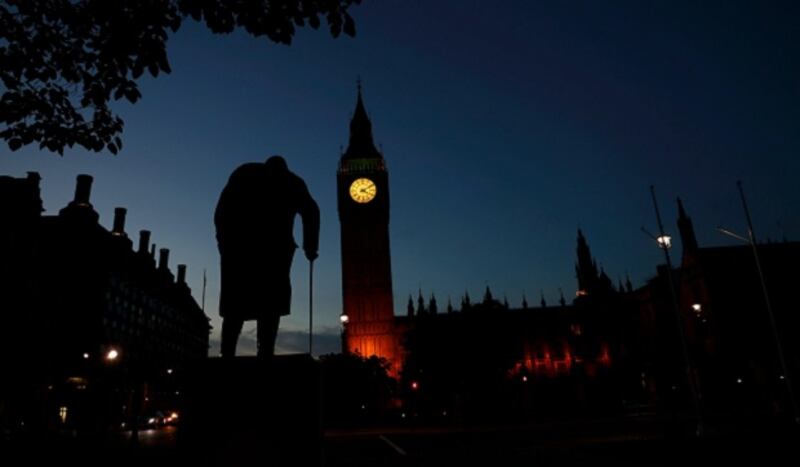 Dawn breaks behind the Houses of Parliament and the statue of Winston Churchill in Westminster this morning. Photograph: Stefan Wermuth/Reuters