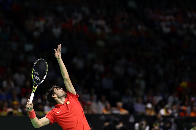 Spain's Carlos Alcaraz plays a serve in his singles match against Tallon Griekspoor. Photograph: Clive Brunskill/Getty Images for ITF