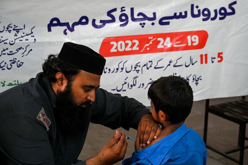 A health worker inoculates a student with a dose of the Pfizer vaccine  at a school in Lahore in September. Photograph: Arif Ali/AFP via Getty Images