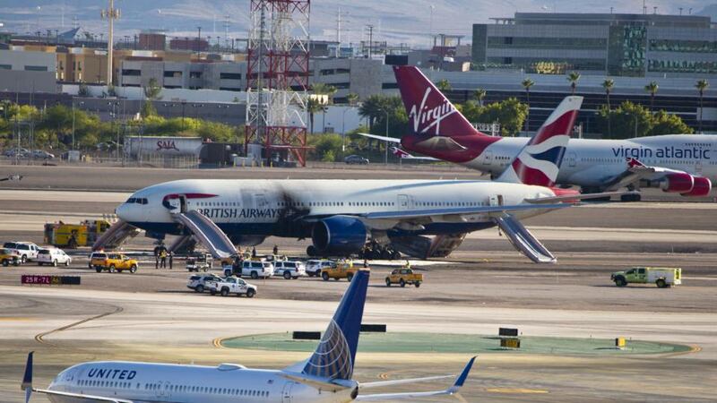 The British Airways plane stands on runway surrounded by emergency vehicles. Photograph: LE Baskow/AFP/Getty Images