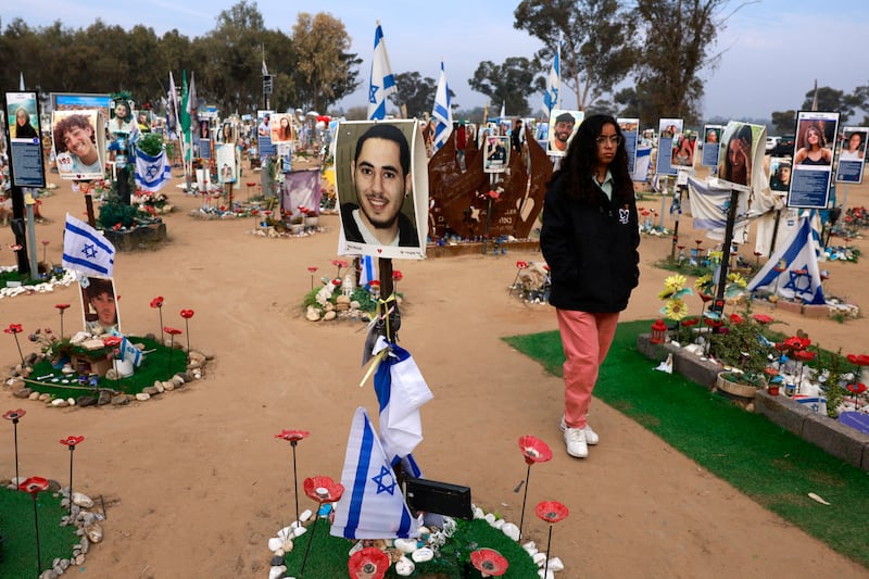 A woman walks past an installation on Thursday on the site of the Nova festival, in Re'im, southern Israel, bearing photographs of victims of the Hamas-led attack on October 7th, 2023. Photograph: Menahem Kahana/AFP via Getty Images