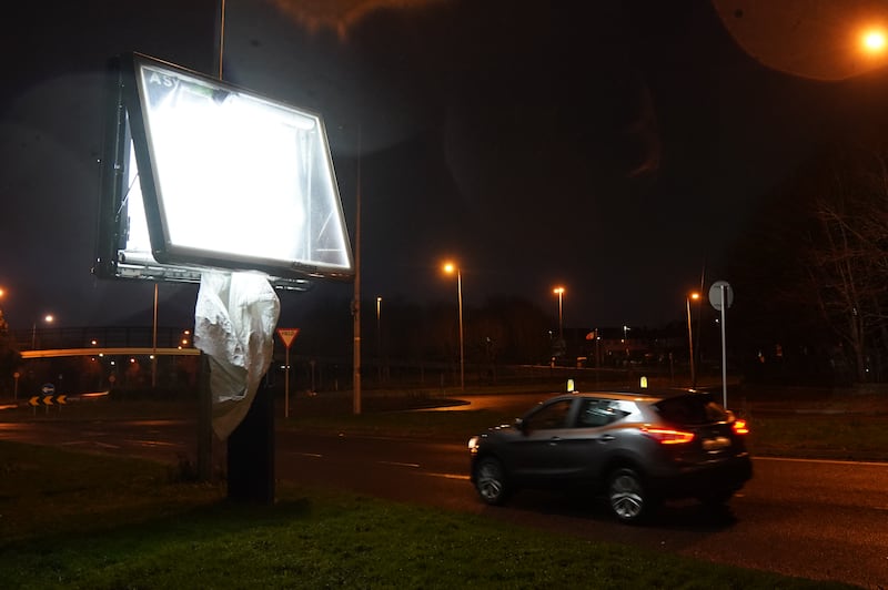 A car passes  an advertising display damaged  by high winds in the Dublin suburb of Finglas. Photograph Brian Lawless/PA Wire