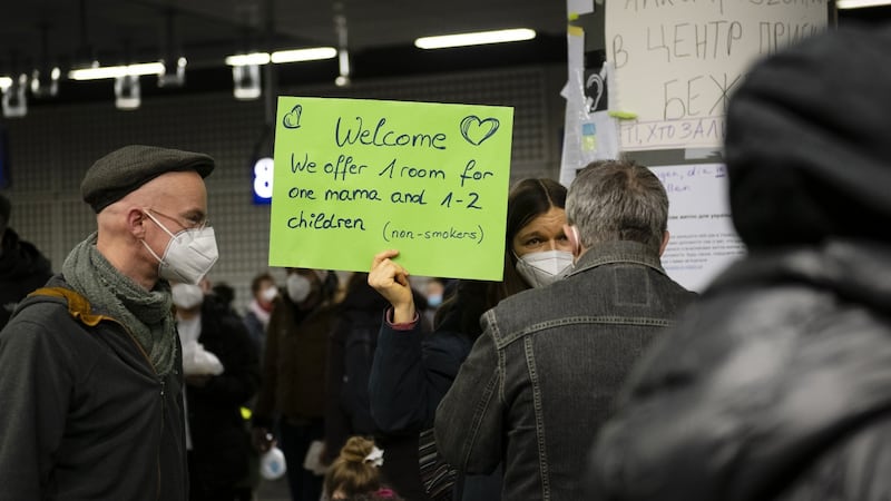 Residents hold up a sign offering accommodation to displaced Ukrainians arriving at Berlin Central railway station  on Wednesday. Photograph: Jacobia Dahm/Bloomberg