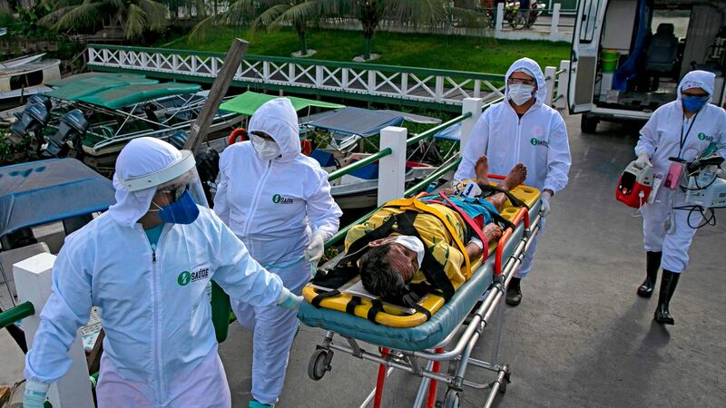 Emergency response personnel carry Covid-19 patient Eladio Lopes (79)  to a hospital in Breves, on Marajo island, Para state, Brazil, on Monday.  Photograph: Tarso Sarraf/AFP via Getty Images