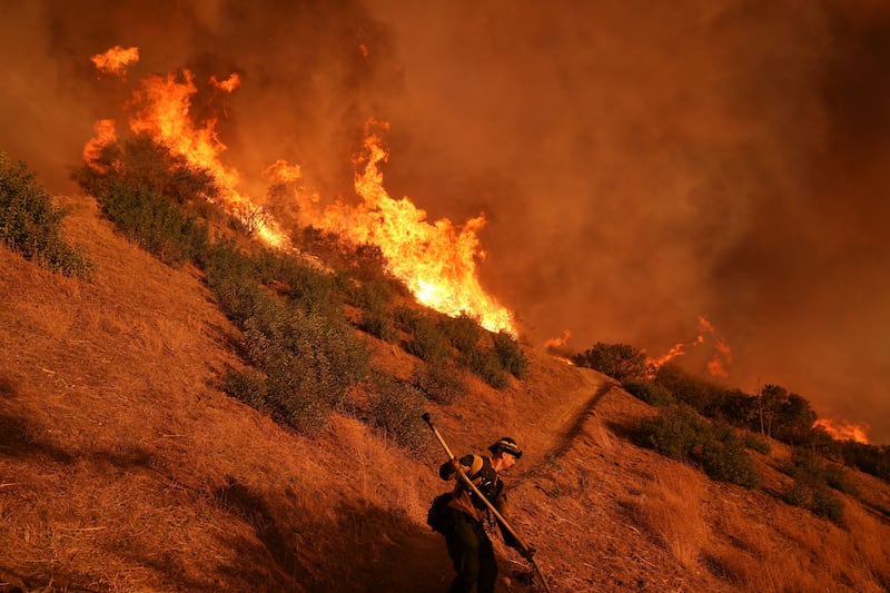 A firefighter battles the Palisades fire in Mandeville Canyon. Photograph: Jae C Hong/AP